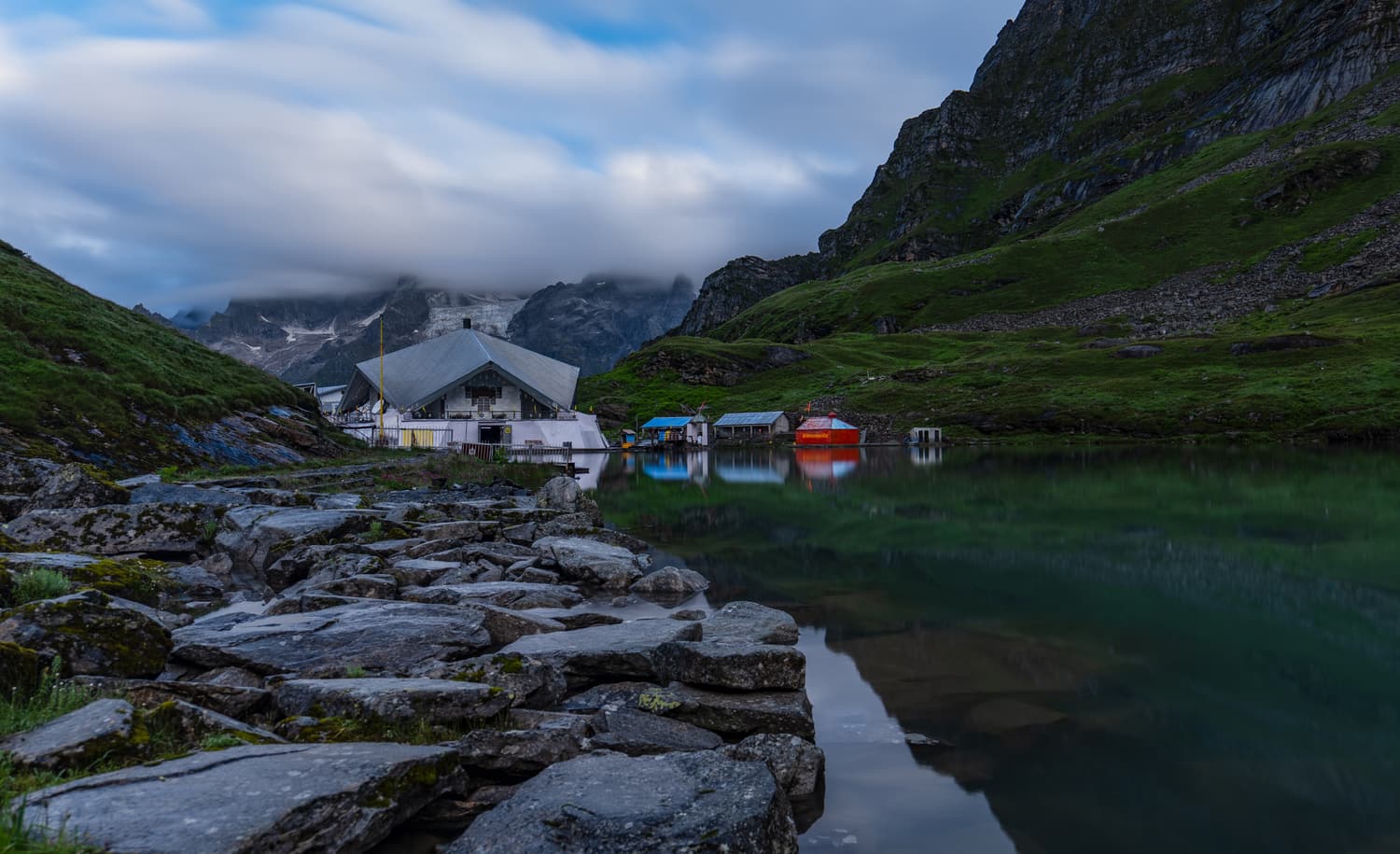 The Hemkund Sahib gurudwara reflected in Lokpal lake below rocky peaks
